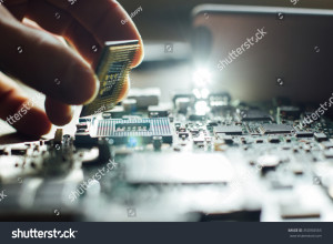 stock-photo-technician-plug-in-cpu-microprocessor-to-motherboard-socket-workshop-background-350350565